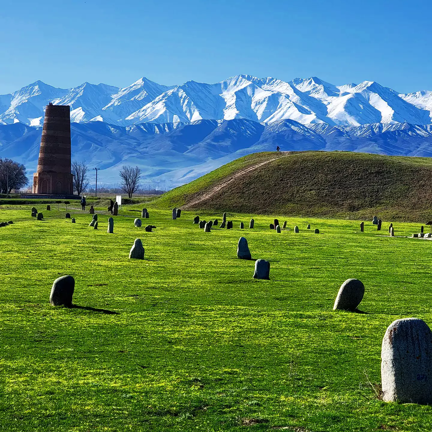 The Burana Tower framed by the snow capped mountains south of the capital of Bishkek.